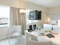 a hotel room with a desk and a bed at Lutecia Smart Design Hotel in Lisbon