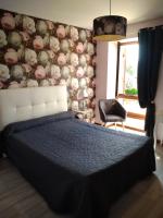 a bedroom with a bed and a wall with flowers at La Ferme Fleurie in La Roque-Gageac