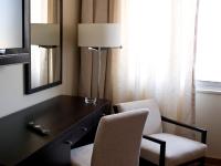 a desk and two chairs in a hotel room at Lutecia Smart Design Hotel in Lisbon
