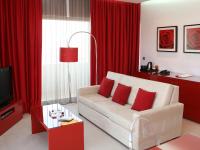 a living room with a white couch and red curtains at Lutecia Smart Design Hotel in Lisbon