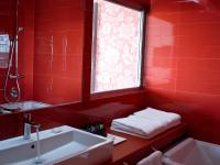 a red bathroom with a sink and a window at Lutecia Smart Design Hotel in Lisbon