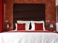 a bedroom with a large bed with red and white pillows at Lutecia Smart Design Hotel in Lisbon