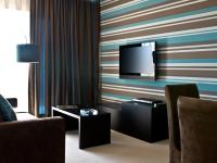 a living room with a television on a striped wall at Lutecia Smart Design Hotel in Lisbon