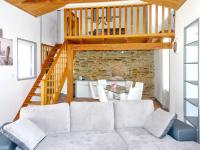 a living room with a couch and a staircase at Maison de 2 chambres a Saint Gilles Croix de Vie a 300 m de la plage avec terrasse amenagee et wifi in Saint-Gilles-Croix-de-Vie