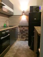 a kitchen with a black refrigerator and a sink at Appartement d&#39;une chambre avec balcon amenage et wifi a Briancon in Briançon