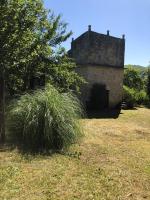 an old building with a large bush in front of it at Maison d&#39;une chambre avec jardin clos a Tour de Faure in Tour-de-Faure