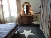 a bedroom with a bed and a mirror and a chair at Toki Alai in Saint-Jean-de-Luz