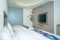 a room with three white beds and a flat screen tv at 日月潭天月水色民宿 (老街-停車-度假）skylight bnb in Yuchi