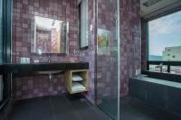 a bathroom with a sink and a glass shower at 日月潭天月水色民宿 (老街-停車-度假）skylight bnb in Yuchi