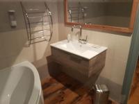 a bathroom with a sink and a toilet and a mirror at Le Betrot in Estissac