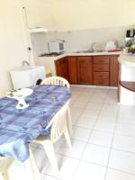 a kitchen with a table with a blue table cloth on it at Appartement de 2 chambres avec jardin clos a Lamentin in Lamentin