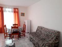 a living room with a couch and a table and a chair at Maison de 3 chambres avec vue sur la mer terrasse et wifi a Vieux Habitants in Vieux-Habitants