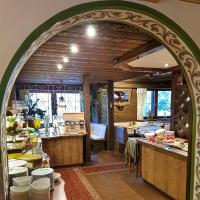 an archway in a kitchen with a table and a counter at Alpenhotel Denninglehen in Berchtesgaden