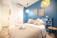 a blue bedroom with a large bed with towels on it at Lovely Home in Paris Center - AC in Paris