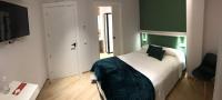 A bed or beds in a room at Hostal León