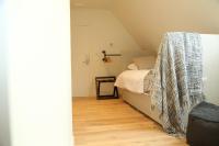 a bedroom with a bed with a blanket on it at B&amp;B Leonie in Alveringem