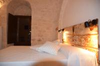A bed or beds in a room at Trulli don Pietro