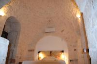 A bed or beds in a room at Trulli don Pietro