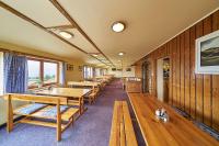 a row of tables and benches in a restaurant at Lyžařská bouda in Pec pod Sněžkou