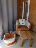 a living room with a chair and a ottoman at Le Theven in Sibiril