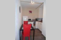 a kitchen with a table and two red chairs at Entre Saint-Tropez et les gorges du Verdon. in Lorgues