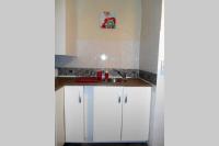 a kitchen with white cabinets and a sink at Entre Saint-Tropez et les gorges du Verdon. in Lorgues