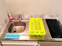 a kitchen sink with two yellow baskets on it at Appartement T1 quartier château de Pau in Pau