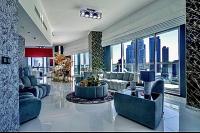 a large living room with a view of a city at Downtown Al Bahar Apartments in Dubai