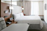a hotel room with a large bed and a chair at Club Quarters Hotel Grand Central, New York in New York