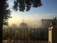 a misty view from a house with a fence at Au Petit Thouars in Thouars