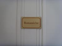 a sign that reads romanerate hanging on a door at La Ceriseraie in La Gorgue