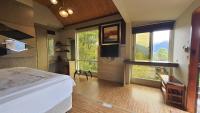 a bedroom with a bed and large windows at Yosemite Park B&amp;B in Ren&#39;ai