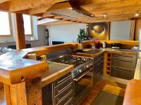 a kitchen with a stove top oven in a room at Ancienne école du Mont in Servoz