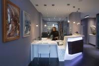 a woman standing behind a counter in a room at Salamanca Suite Studios in Salamanca