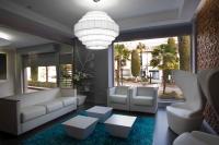 a living room with white furniture and a large window at Salamanca Suite Studios in Salamanca