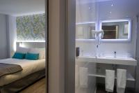 a bathroom with a bed and a sink and a mirror at Salamanca Suite Studios in Salamanca