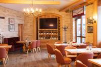 a restaurant with tables and chairs and a flat screen tv at Ice Angels Hotel in Borovets