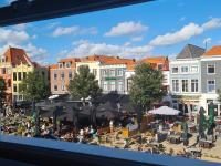 a view of a city with tables and umbrellas at Rijksmonument Havenzicht, met zeezicht, ligging direct aan zee en centrum in Vlissingen