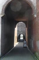 an empty chair in an archway in a brick tunnel at Rijksmonument Havenzicht, met zeezicht, ligging direct aan zee en centrum in Vlissingen