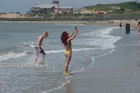 a man and a woman standing in the water at the beach at Rijksmonument Havenzicht, met zeezicht, ligging direct aan zee en centrum in Vlissingen