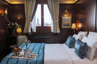 a hotel room with a bed and a table with teaitures at Hotel Bucintoro in Venice