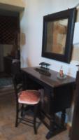 a desk with a chair and a mirror on a wall at TRADITIONAL HOUSE MARIA in Azoyirás
