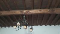 a chandelier hanging from a wooden ceiling at TRADITIONAL HOUSE MARIA in Azoyirás