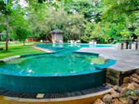 a large pool with a hot tub in a yard at Nil Diya Mankada Safari Lodge in Udawalawe