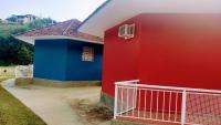 a colorful house with a gate in front of it at Pousada Mama África in Conservatória