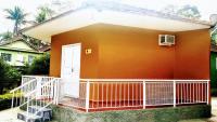 a small house with a porch and a white door at Pousada Mama África in Conservatória