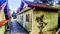 a small green building with a potted plant next to it at Pousada Mama África in Conservatória