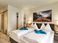Łóżko lub łóżka w pokoju w obiekcie Hotel Sportwelt