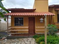 a small yellow house with a red roof at Pousada Bougainville in Três Corações