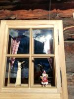 a window of a house with two dolls in it at Tradlhof in Thierbach